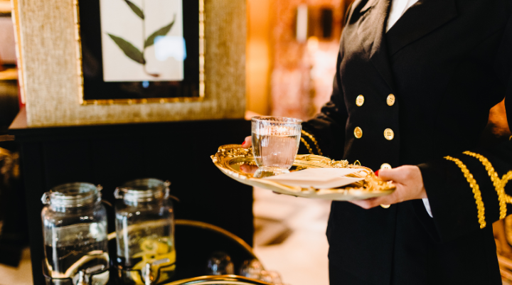 A waiter holding a tray of drinks