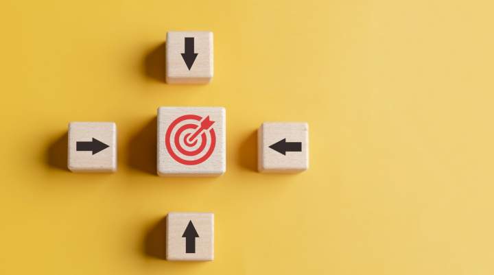 Yellow background, four arrows pointing to a bullseye