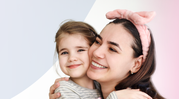 Mother and daughter hugging and smiling 