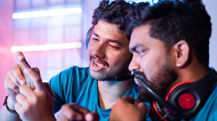 Two men looking at a phone screen