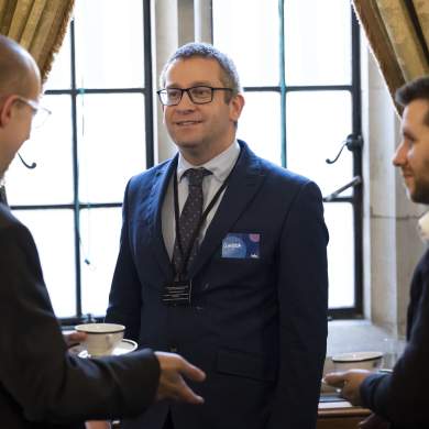 Three men engaged in conversation