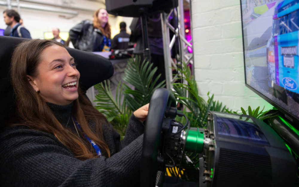 member playing car games at gaming media upfronts 